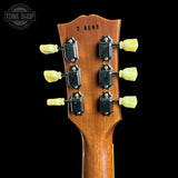 Guitar headstock with tuning pegs on a black background, featuring 'Tone Shop' logo.