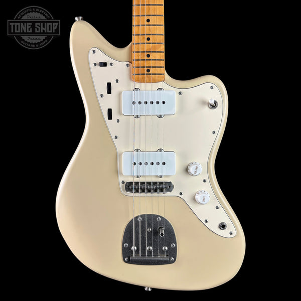 Cream-colored electric guitar with a maple neck, dual humbucker pickups, and a chrome tailpiece, shown against a solid black background with a Tone Shop watermark in the top left corner.