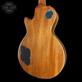 Wooden guitar body with 'Tone Shop' logo in the corner