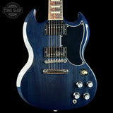 A blue electric guitar with a glossy dark blue finish, featuring a black pickguard, chrome hardware, and silver control knobs, shown against a solid black background.