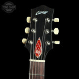 Close-up of a Collings 290 acoustic guitar headstock and upper neck against a black background, showing the dark wood headstock, cream tuning pegs, and red-and-white 290 badge.