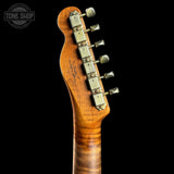 Close-up of a guitar neck with tuning pegs on a black background, featuring the Tone Shop logo.
