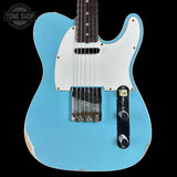 Blue electric guitar with a white pickguard on a black background, featuring 'Tone Shop' branding.