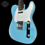Blue electric guitar with white pickguard on a black background, featuring 'Tone Shop' logo.