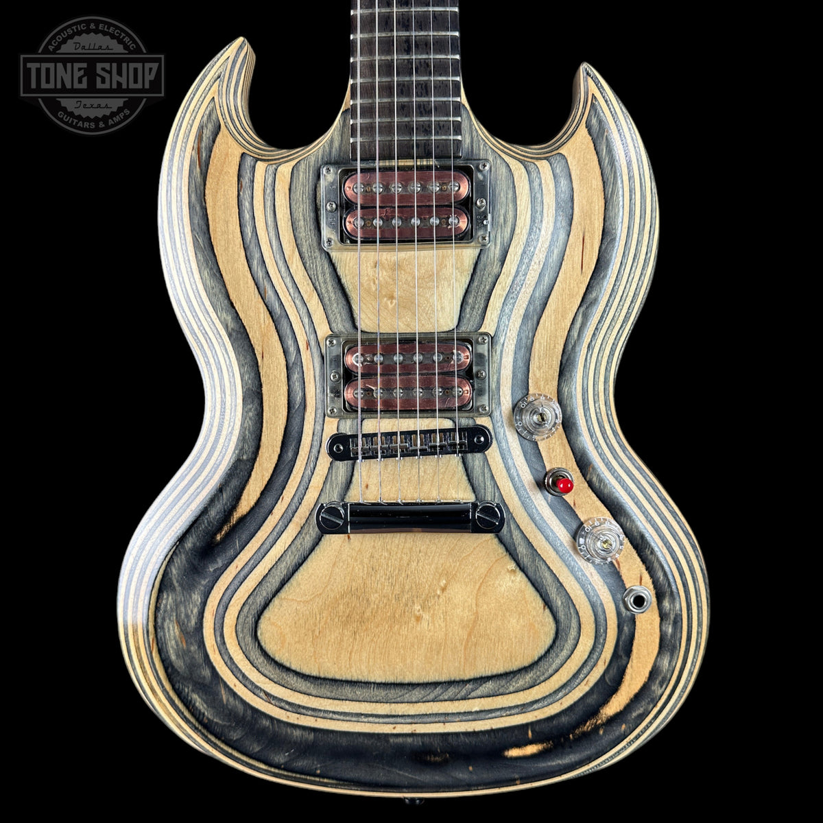 A double-cutaway electric guitar with a distinctive wavy striped natural wood finish, featuring a light maple top, dark wood grain lines, and dual humbucker pickups, shown against a solid black background.