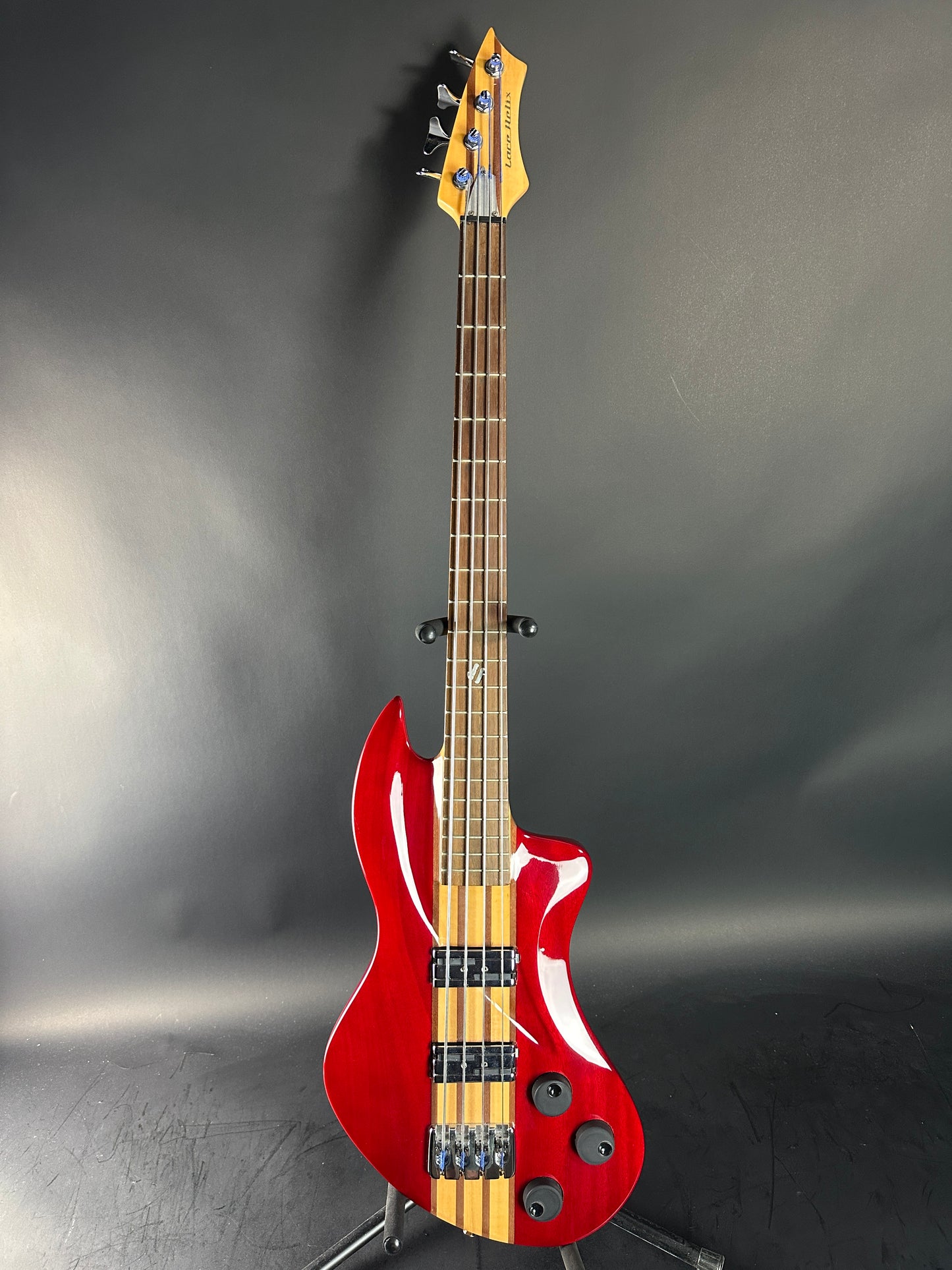 Red electric bass guitar on a gray background