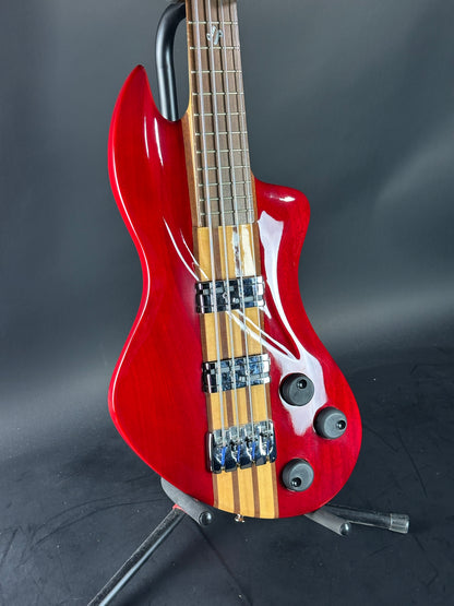 Red electric bass guitar on a dark background