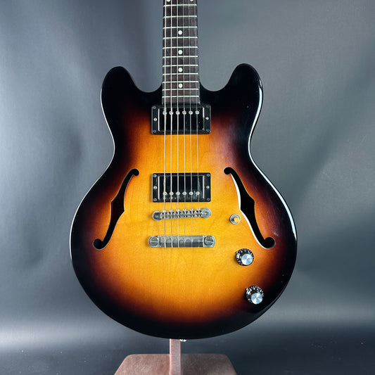 Electric guitar with a sunburst finish on a gray background