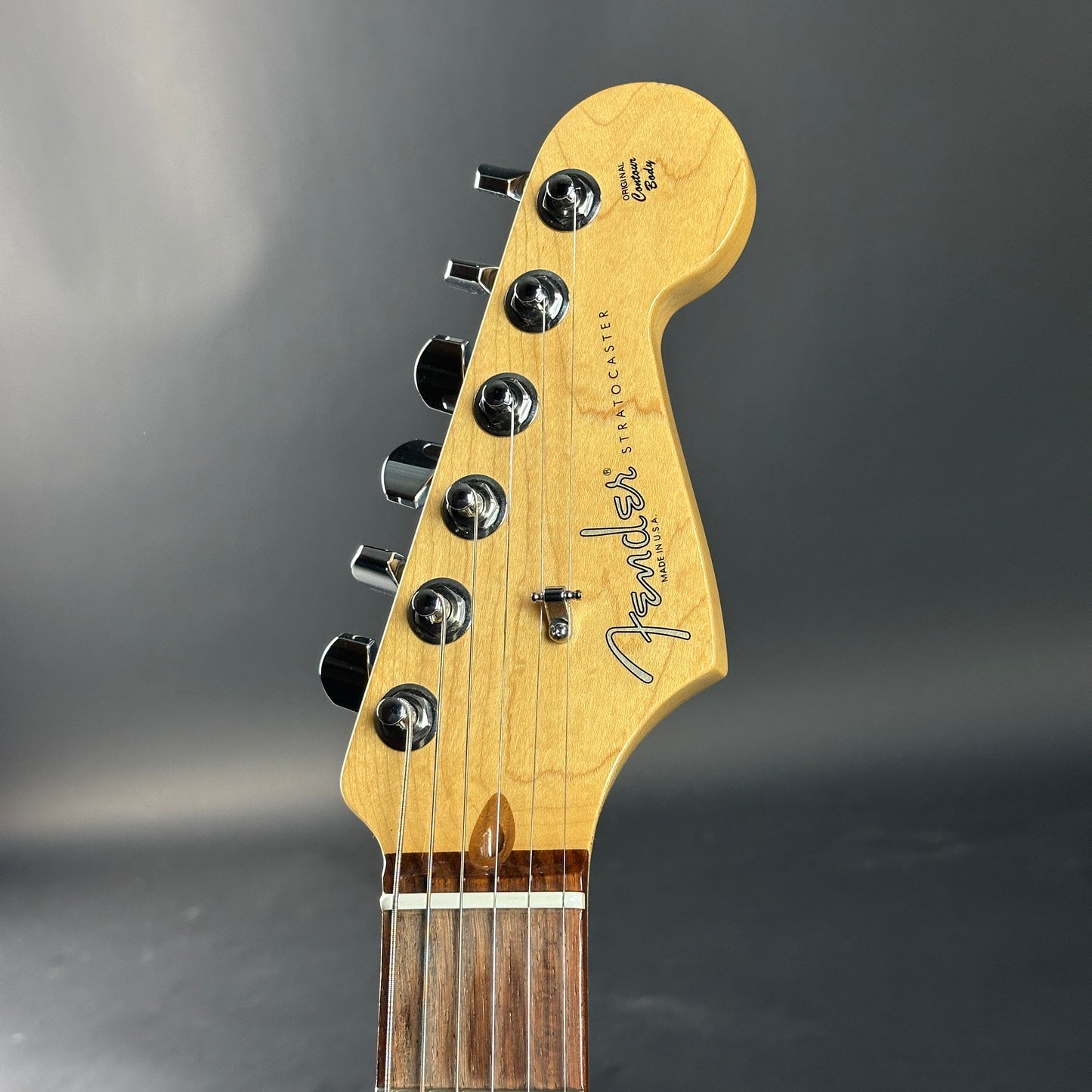 Fender guitar headstock on a gray background