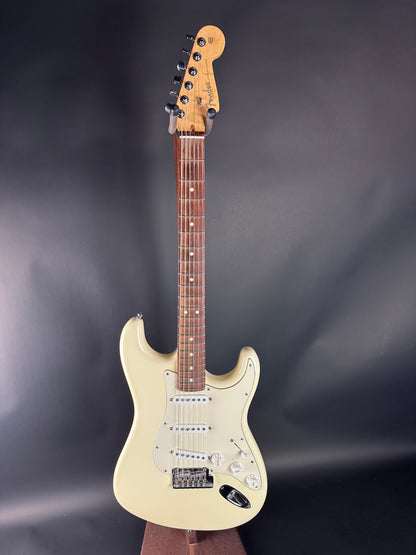 White electric guitar on a dark gray background