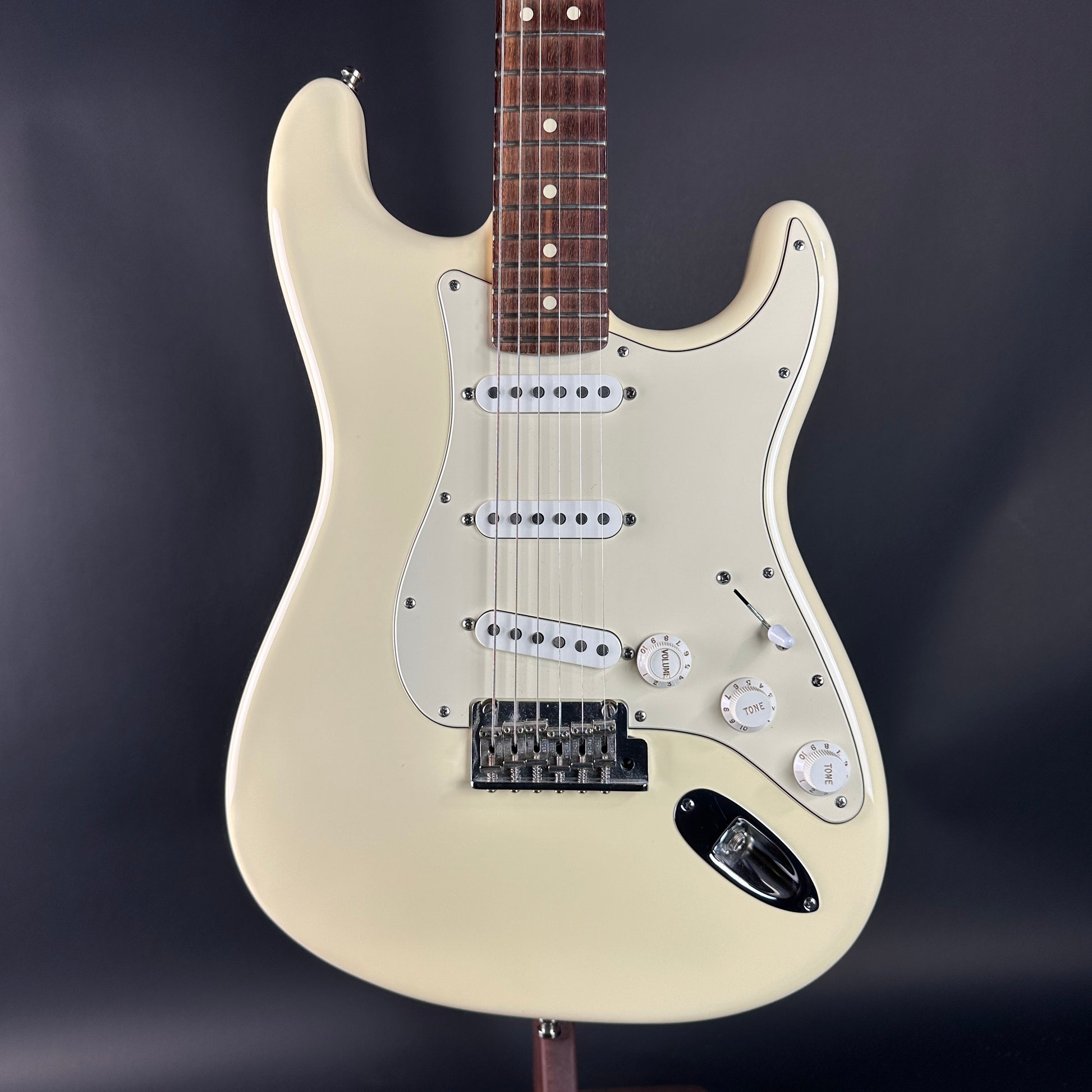 Beige electric guitar on a dark background