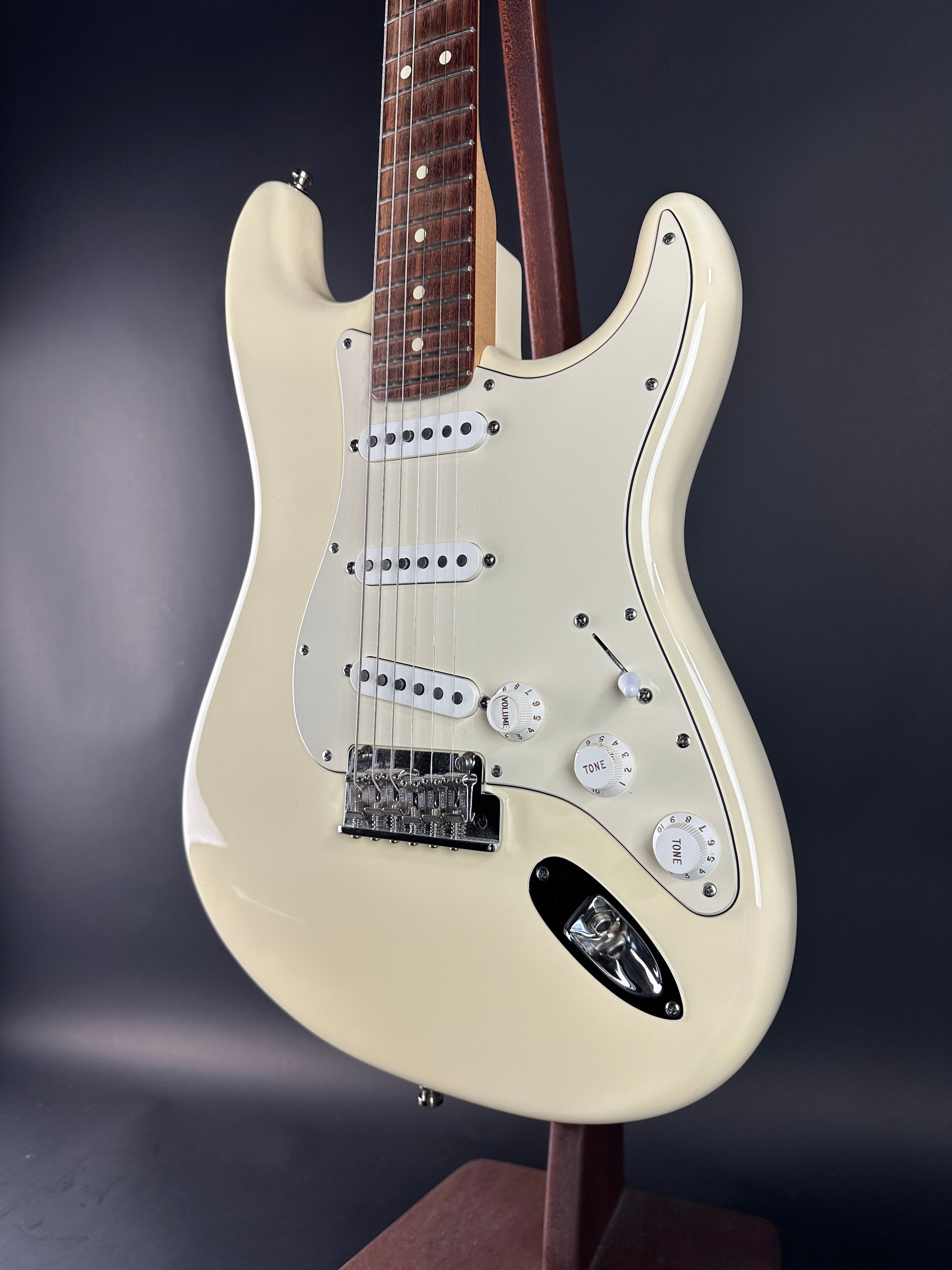 White electric guitar on a dark background