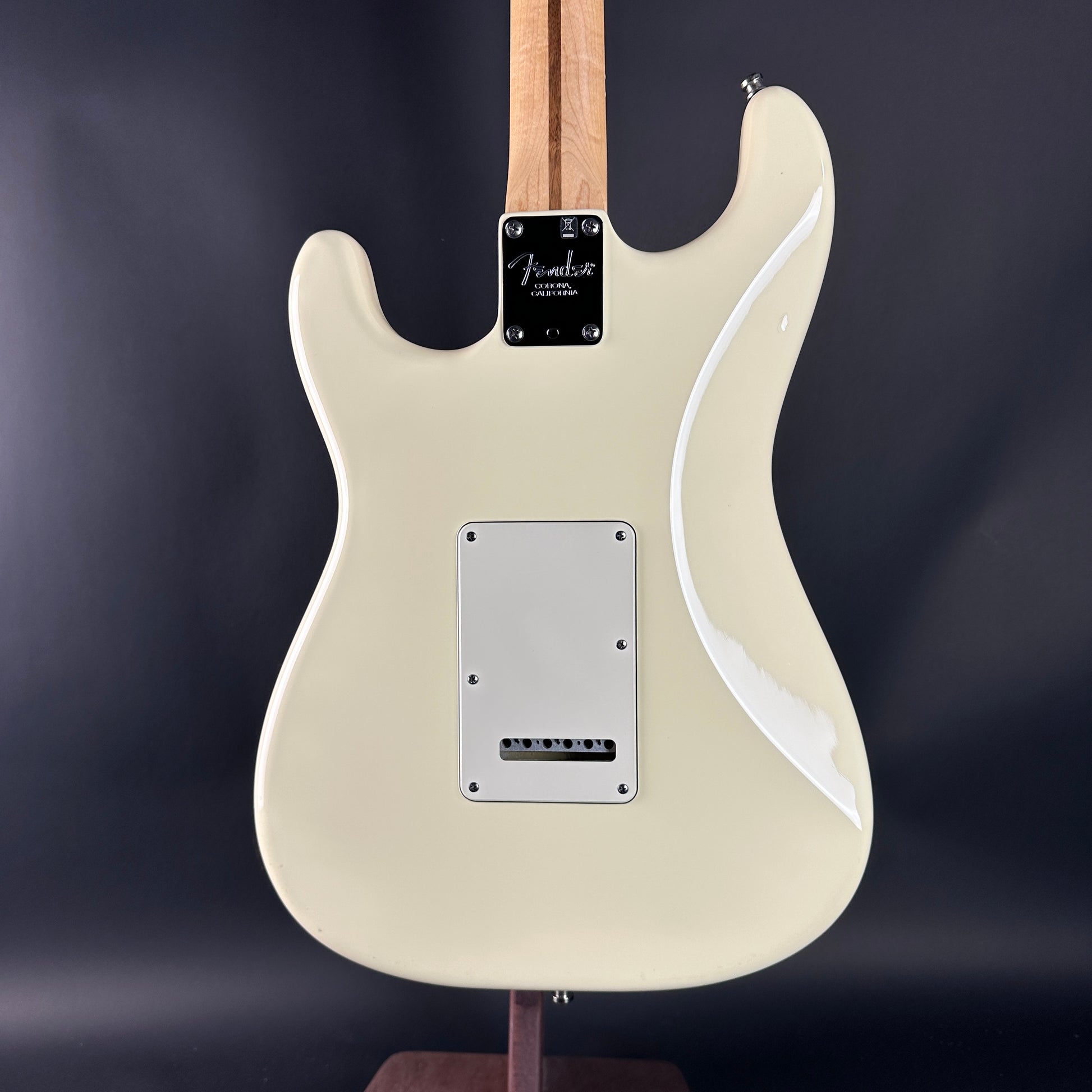White electric guitar with a dark background