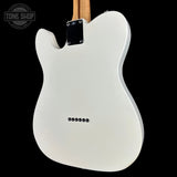 The back of a white electric guitar with a black control plate and silver screws, shown against a solid black background with a Tone Shop watermark in the top left corner.