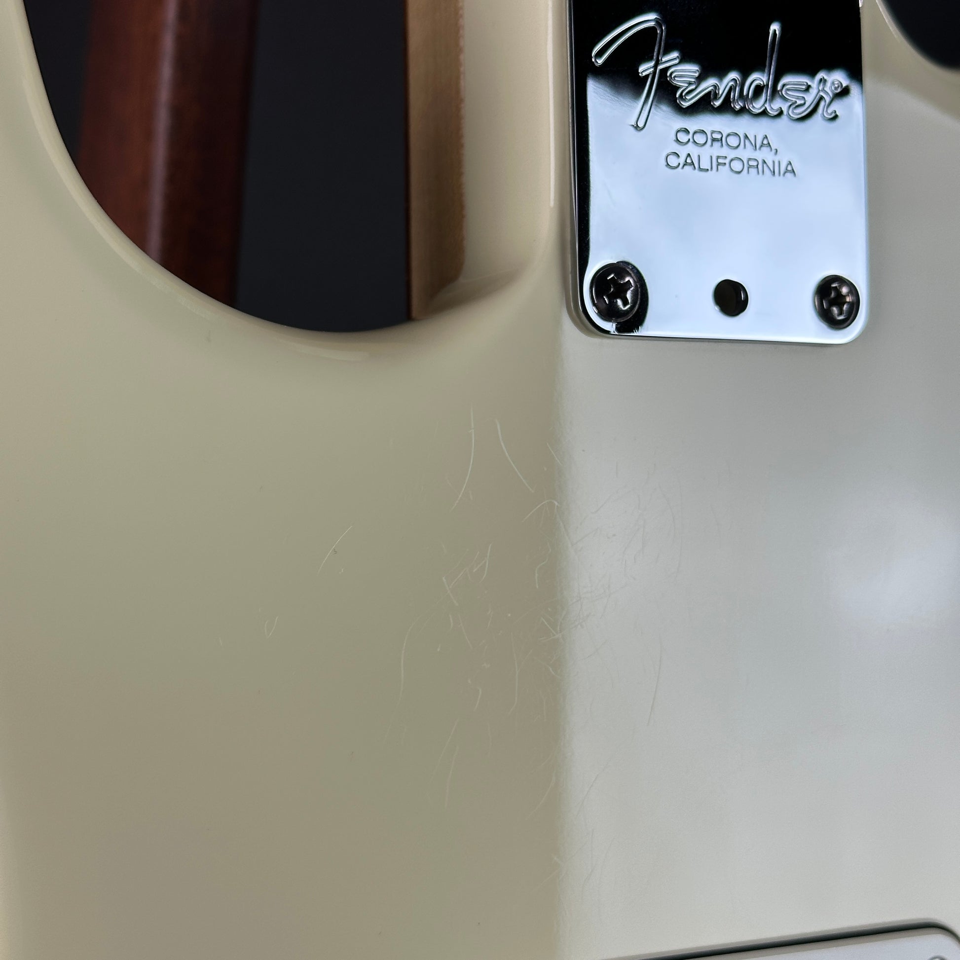 Fender guitar with 'Corona, California' label on a beige background