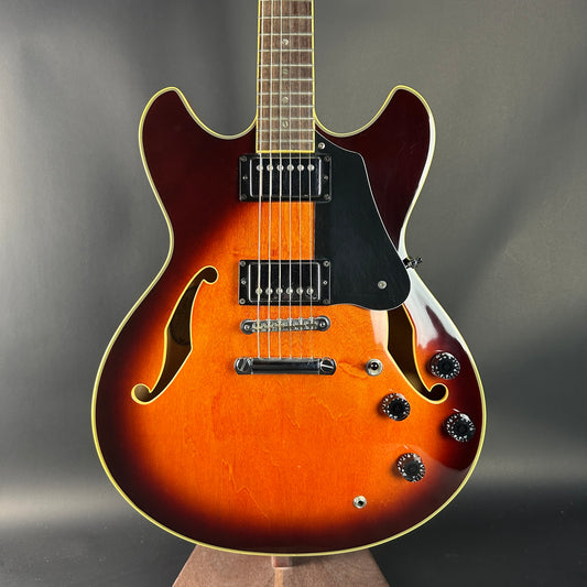 Electric guitar with a sunburst finish on a gray background
