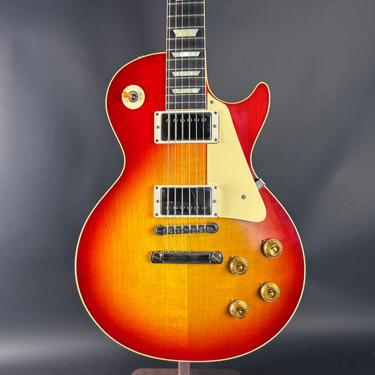 Electric guitar with a sunburst finish on a dark background