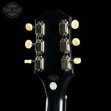 Guitar headstock with tuning pegs on a black background, featuring the Tone Shop logo.