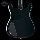 Back view of a black electric guitar with 'Tone Shop' logo.