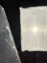 Close-up of a clear plastic sheet with a black border