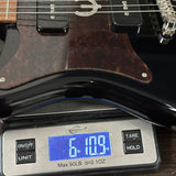 Guitar on a digital scale displaying weight