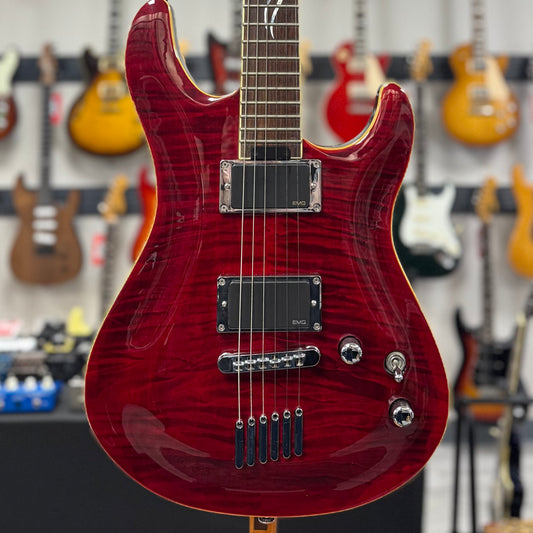 Red electric guitar with a blurred background of other guitars