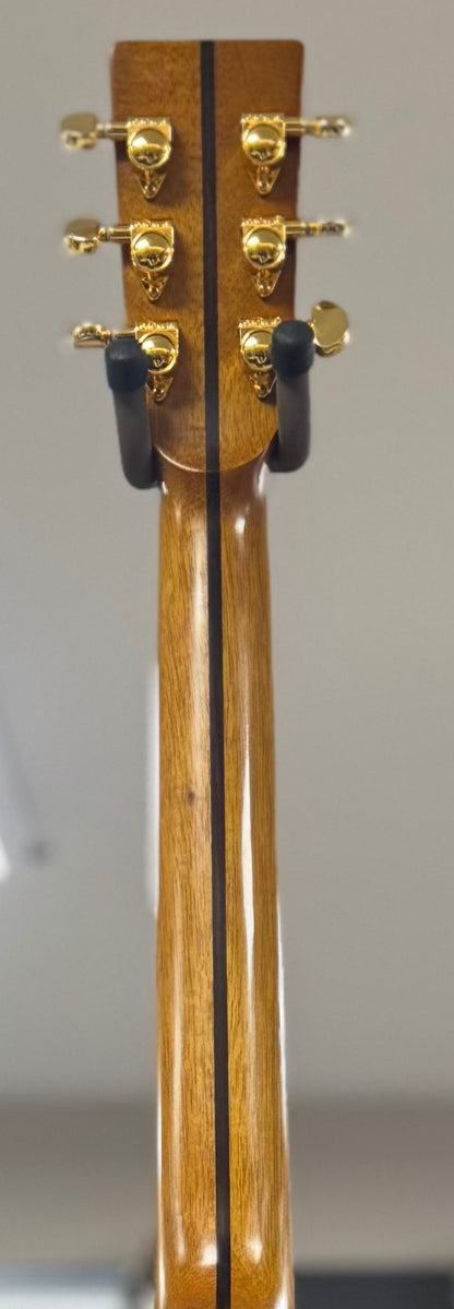 Close-up of a guitar's headstock with tuning pegs on a gray background