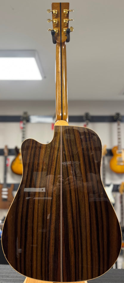 Acoustic guitar with a wooden finish in a store setting