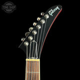 Gibson guitar headstock with brand logo on a black background