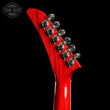 Close-up of a red electric guitar's headstock with tuning pegs on a black background, featuring 'Tone Shop' logo.