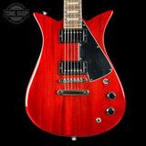 Red electric guitar with a black pickguard on a black background, featuring 'Tone Shop' branding.