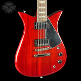 Red electric guitar with a black pickguard on a white background