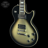 A Les Paul style electric guitar with a black-to-gold sunburst finish, shown against a solid black background. The brand 'Tone Shop' is watermarked in the top-left corner.