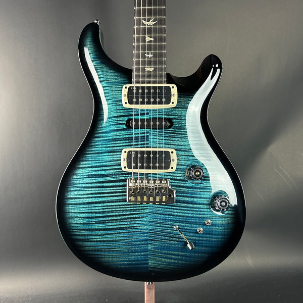 Blue electric guitar on a gray background