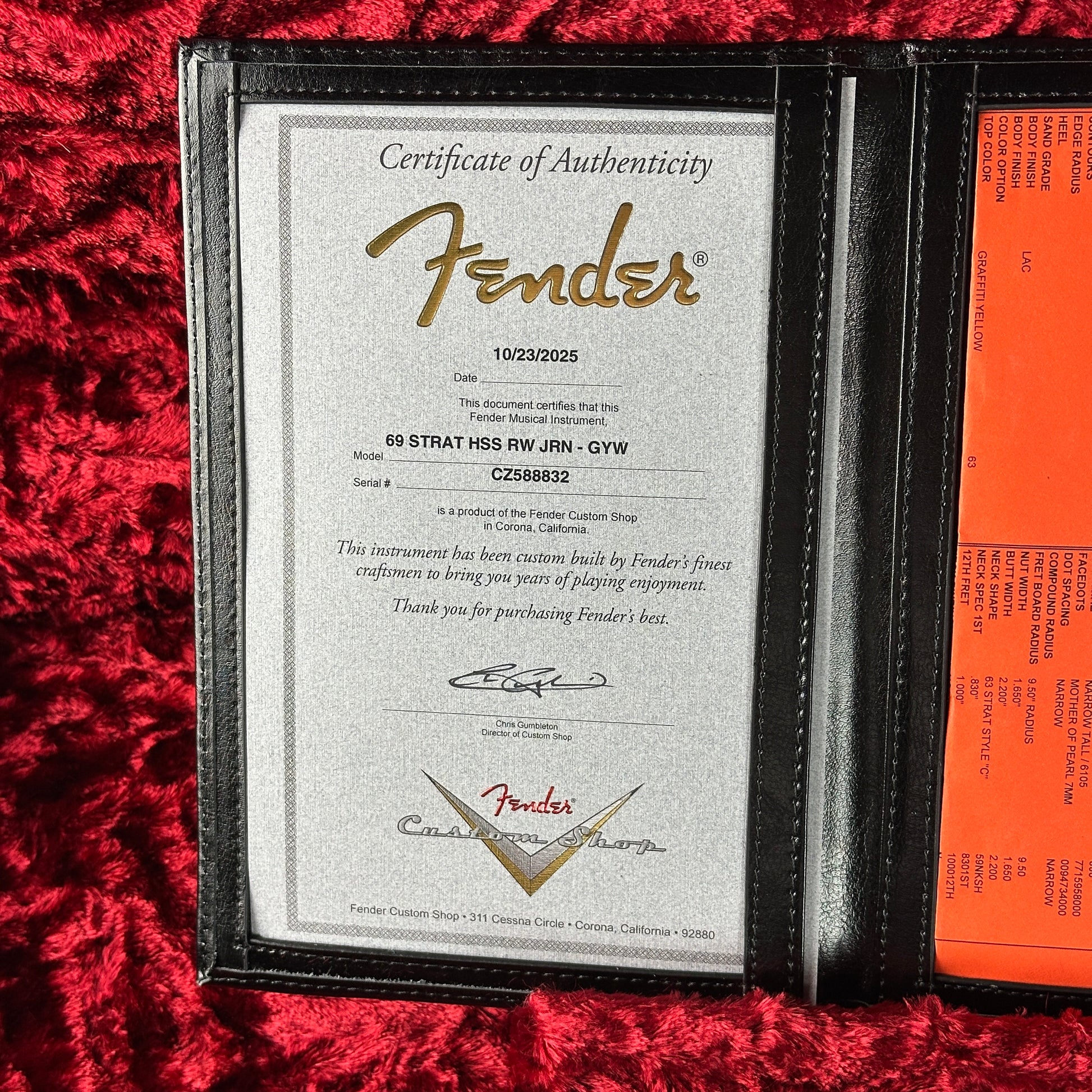 Fender certificate of authenticity on a red textured surface