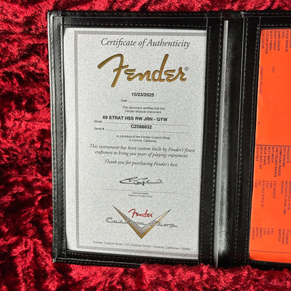Fender certificate of authenticity on a red textured surface