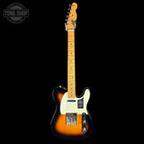 A classic Fender Telecaster electric guitar with a sunburst finish, shown vertically against a solid black background. The guitar features a natural maple neck, a cream pickguard, and a black, brown, and orange sunburst body.
