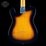 The back of a Fender Telecaster electric guitar, showing the classic sunburst finish that transitions from a bright amber-orange center to a dark black edge, with a maple neck and chrome hardware visible against a solid black background.