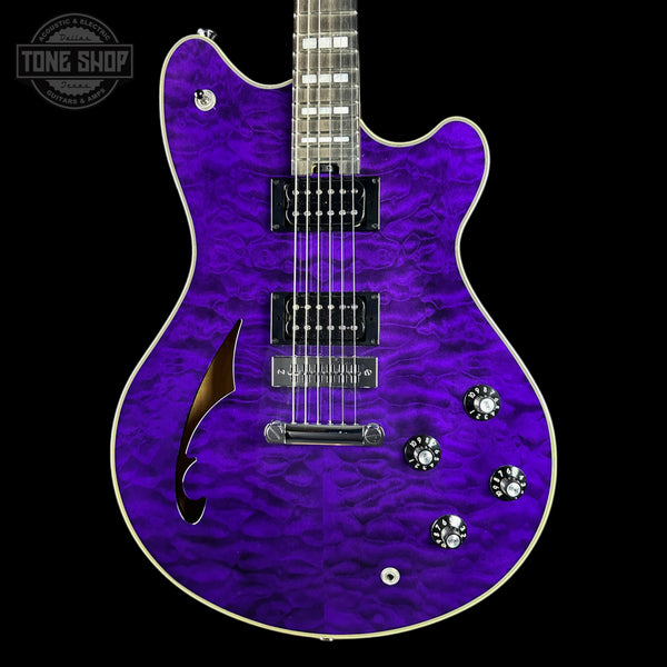 A purple electric guitar with a flamed maple top and black pickups, shown against a black background with a Tone Shop watermark in the top left corner.