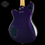 The rear view of an electric guitar body in a glossy deep purple finish, featuring a maple wood neck, chrome hardware, and a black pickguard, shown against a solid black background with a Tone Shop watermark in the top-left corner.