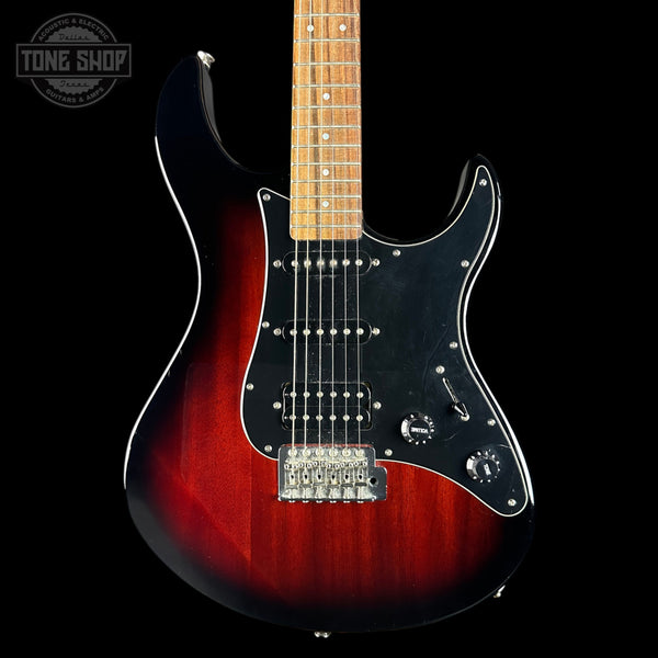 Electric guitar with a red and black finish on a black background, featuring the Tone Shop logo.