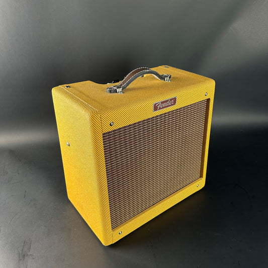 Yellow Fender amplifier on a gray background