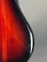 Close-up of a guitar's soundhole with a red and black finish.
