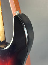 Close-up of a guitar capo on a guitar with a gray background
