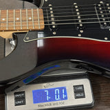 Electric guitar on a digital scale displaying weight