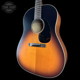 Acoustic guitar with a sunburst finish on a black background, featuring the Tone Shop logo.