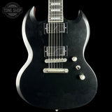 Black electric guitar with silver hardware on a black background, featuring 'Tone Shop' logo.