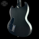 Black electric guitar body with visible brand logo on a black background