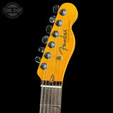 Fender guitar headstock with brand logo on a black background