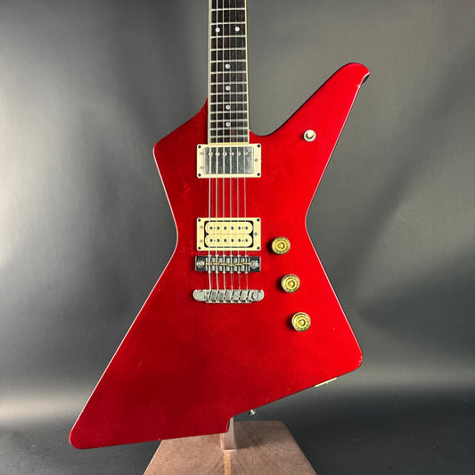 Red electric guitar on a gray background